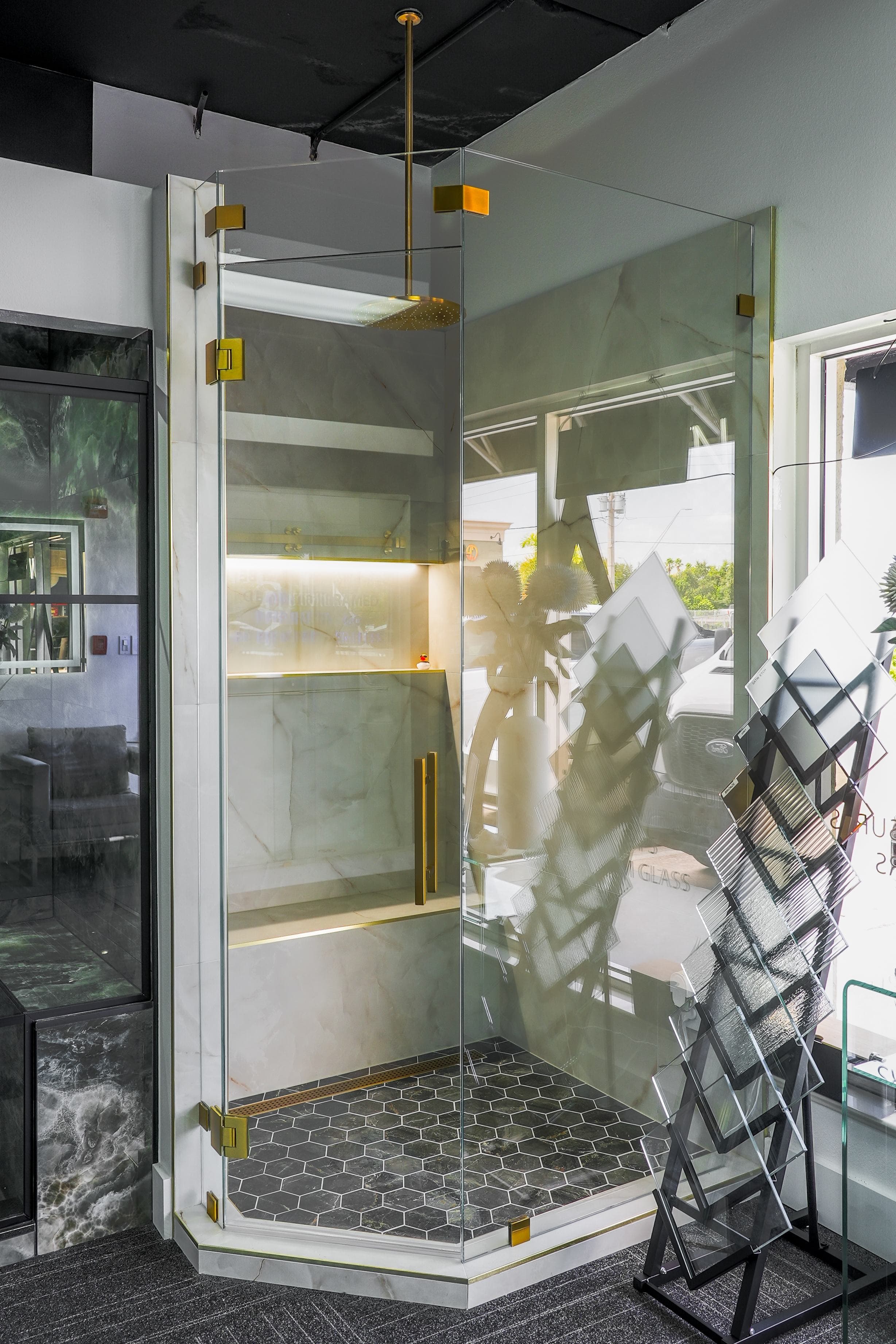 Luxury frameless corner shower enclosure with gold hardware